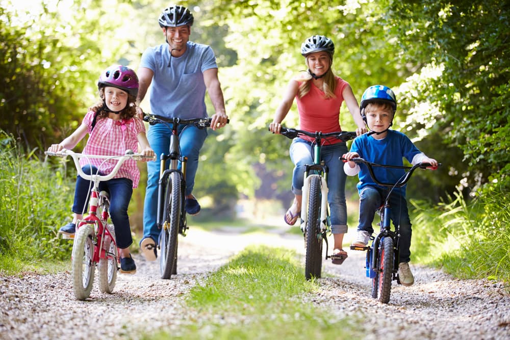 family riding bike in the summer