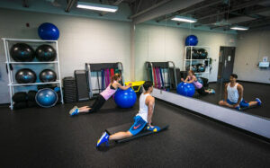 Two people using the fitness studio at Accora Village