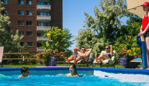 People lounging at the outdoor swimming pool at Accora Village