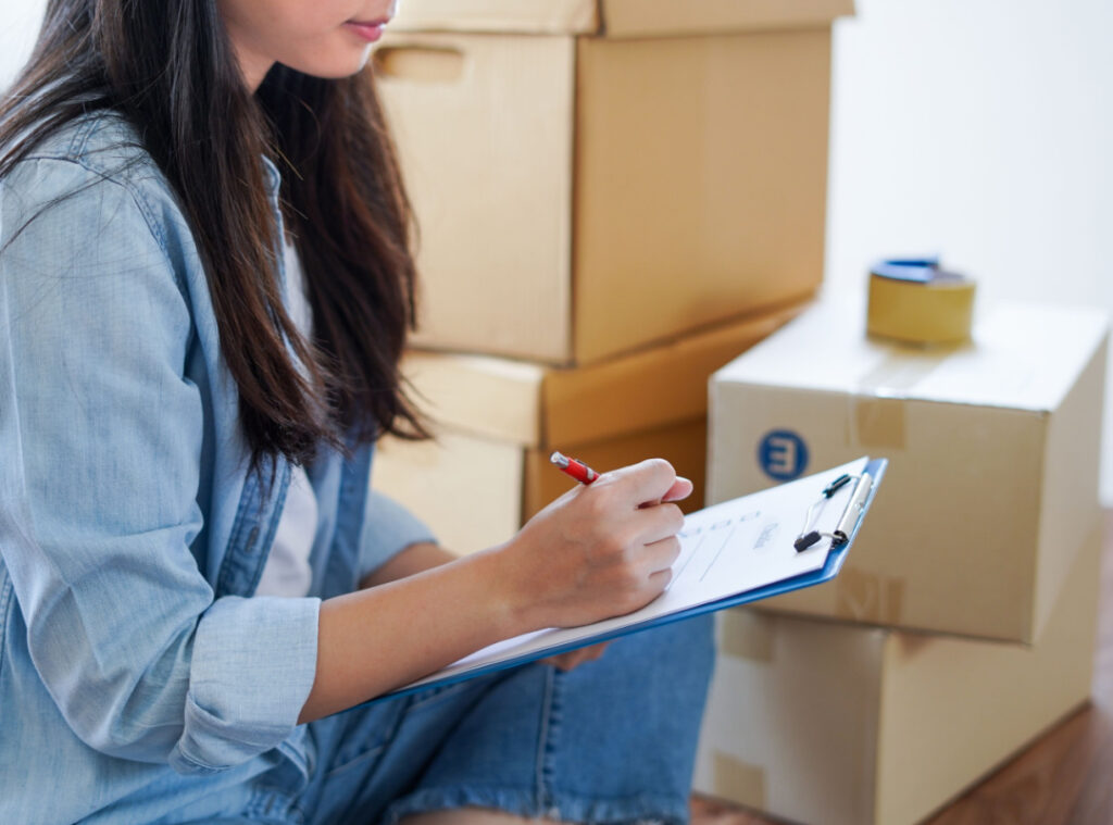 woman holding a moving checklist on a clipboard